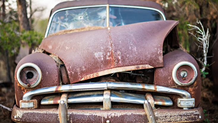 junk car abandoned on a farm